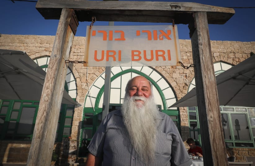 Israeli restaurateur Uri Yirmias stands outside his world-famous fish restaurant 'Uri Buri' in the Old City of Acre, in 2016. (photo credit: NATI SHOHAT/FLASH90)
