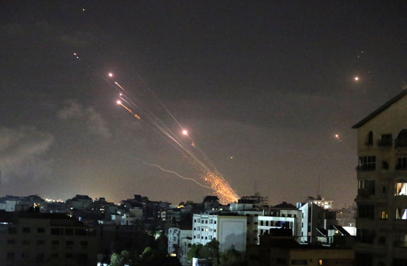 Rockets are launched by Palestinian militants into Israel, in Gaza May 12, 2021. (photo credit: REUTERS/IBRAHEEM ABU MUSTAFA)