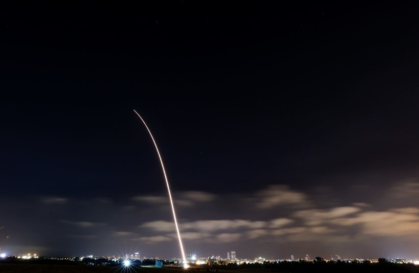 An Iron Dome is seen above Ashdod intercepting a rocket fired into Israel from the Gaza Strip, on May 12, 2021. (photo credit: YONATAN SINDEL/FLASH90)