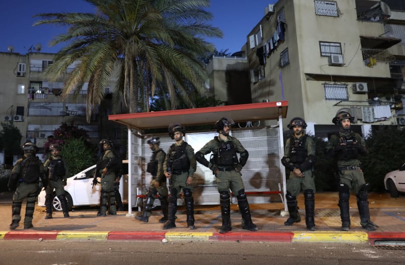Israeli police seen on the streets of the central Israeli city of Lod, where last night synaogues and cars were torched as well as shops damaged, by Arab residents rioted in the city, and ongoing this evening. May 12, 2021. (photo credit: YOSSI ALONI/FLASH90)