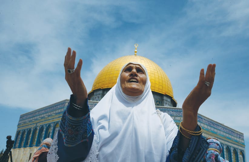 A WOMAN PRAYS on the compound known to Muslims as the Noble Sanctuary and to Jews as the Temple Mount, in Jerusalem’s Old City, last Friday. (photo credit: JAMAL AWAD/FLASH90)