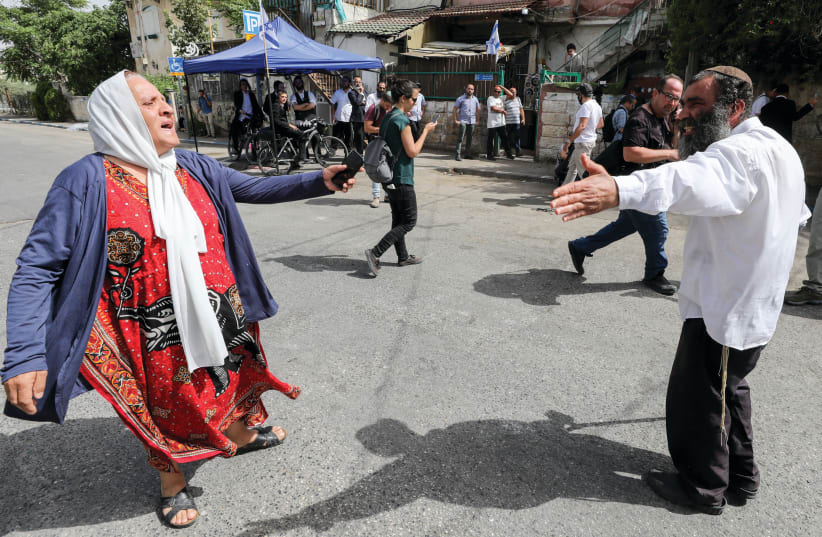 A JEW AND and Arab face off in Sheikh Jarrah on Sunday. (photo credit: OLIVIER FITOUSSI/FLASH90)