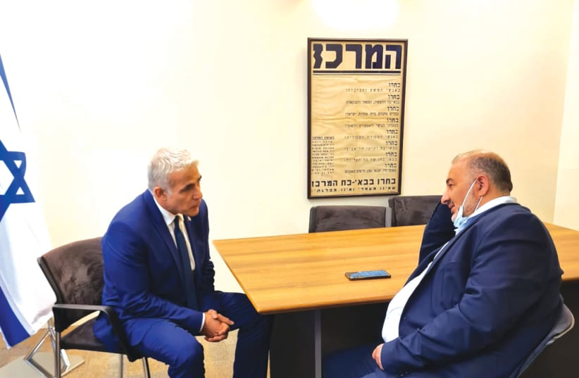 YESH ATID leader Yair Lapid meets with the head of Ra’am, Mansour Abbas. (photo credit: COURTESY LAPID’S OFFICE)