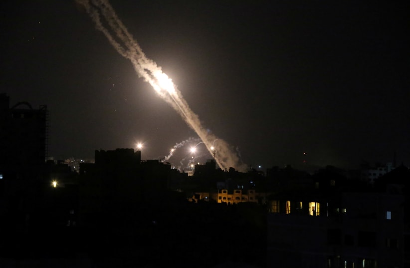 Rockets are launched by Palestinian militants into Israel, in Gaza May 13, 2021. (photo credit: REUTERS/IBRAHEEM ABU MUSTAFA)