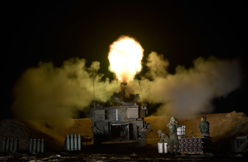 An IDF artillery unit fires towards Gaza Strip near the Israel-Gaza border in Southern Israel, May 13, 2021. (photo credit: GILI YAARI/FLASH90)