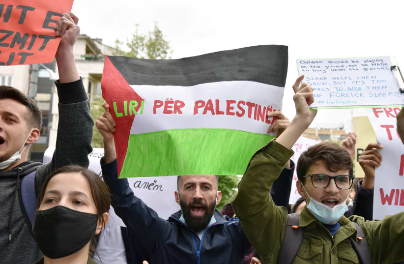 Kosovo Albanians shout slogans and hold banners against violence in Gaza and in support for the free Palestine during a march in Pristina (photo credit: REUTERS/LAURA HASANI)