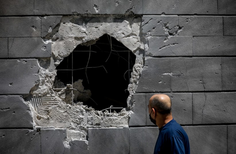 A rocket hits an Ashkelon building, leaving a hole in the wall amid Gaza escalations (photo credit: YONATAN SINDEL/FLASH90)