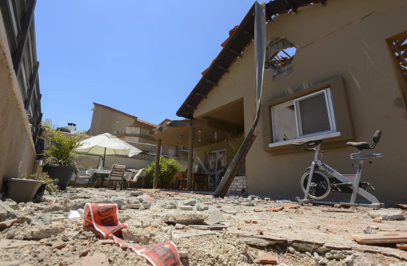 Damage to a house in the Israeli city of Sderot which was hit by rockets fired by Hamas militants in Gaza, into Israel. May 15, 2021. (photo credit: AVI ROCCAH/FLASH90)