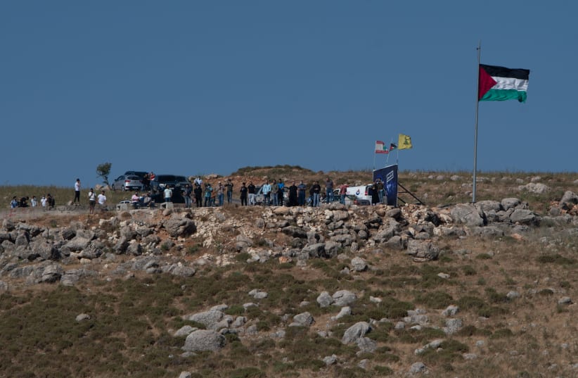 Lebanese protesters seen on the border between Israel and Lebanon, northern Israel, as it seen from Metula, May 15, 2021.  (photo credit: BASEL AWIDAT/FLASH90)