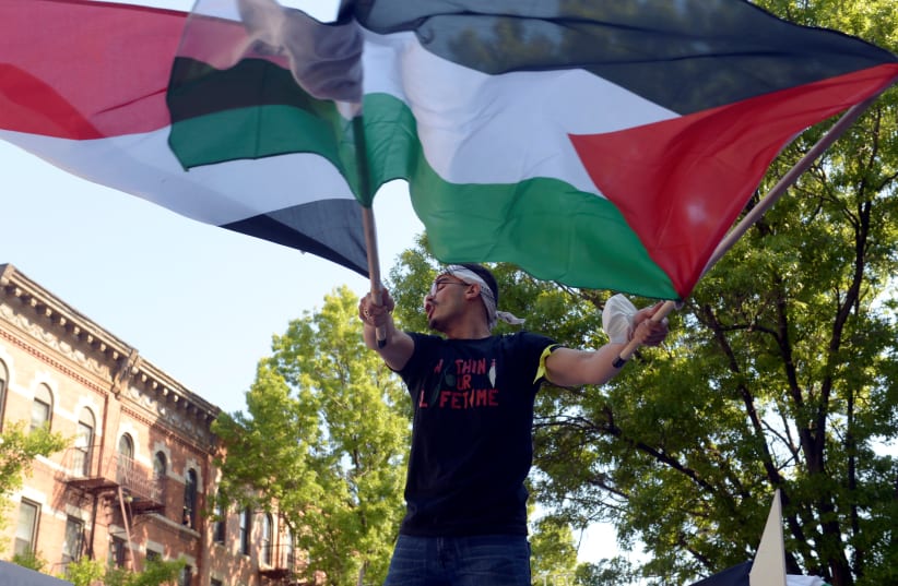 Palestinians and pro-Palestinian supporters protest against Israeli attacks on Gaza amid days of conflict between the two sides, in Brooklyn, New York, US, May 15, 2021. (photo credit: RASHID UMAR ABBASI / REUTERS)