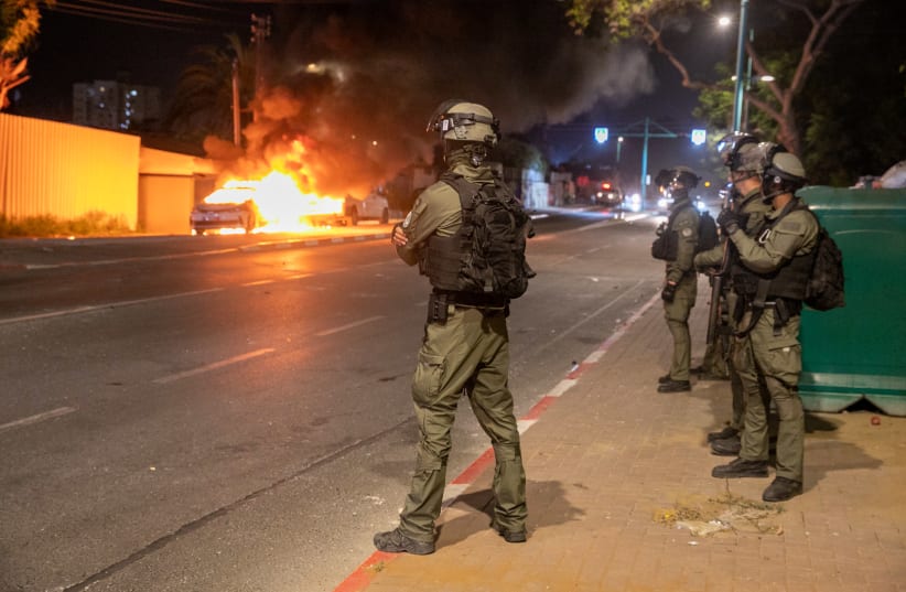 Israeli police seen on the streets of the central Israeli city of Lod, where last night synagogues and cars were torched as well as shops damaged, by Arab residents rioted in the city, and ongoing this evening. May 12, 2021. (photo credit: YOSSI ALONI/FLASH90)