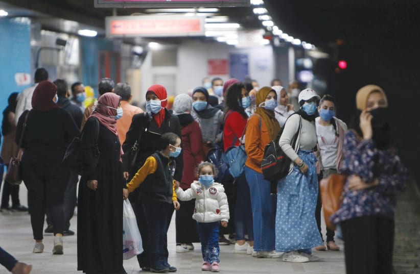 EGYPTIAN WOMEN await the metro at the the underground Al Shohadaa ‘Martyrs’ station, in Cairo in November (photo credit: MOHAMED ABD EL GHANY/ REUTERS)