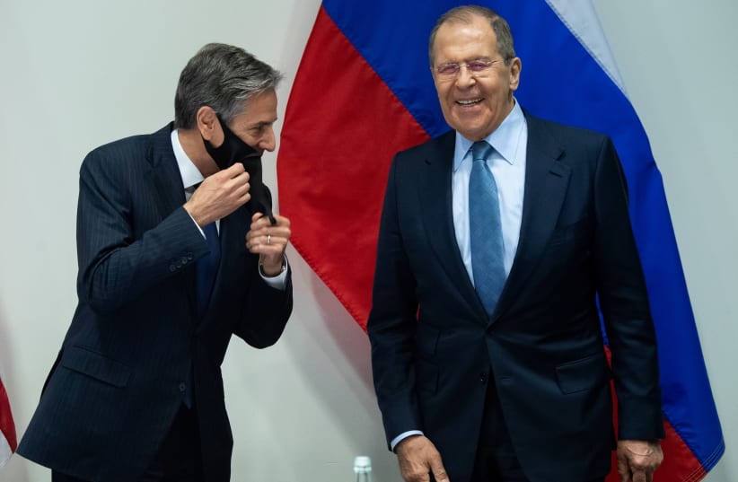 US Secretary of State Antony Blinken and Russian Foreign Minister Sergey Lavrov laugh as they arrive for a meeting at the Harpa Concert Hall, on the sidelines of the Arctic Council Ministerial summit, in Reykjavik, Iceland, May 19, 2021 (photo credit: SAUL LOEB/POOL VIA REUTERS)