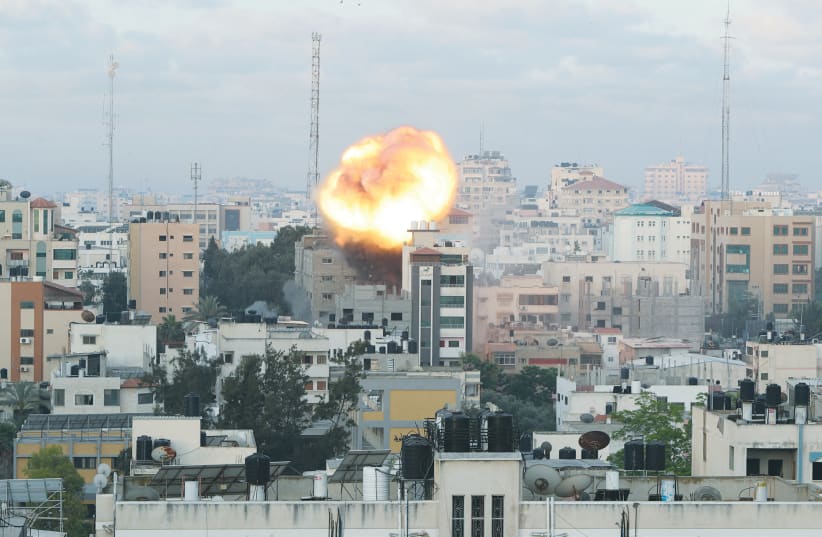 SMOKE AND FLAMES follow an Israeli air strike on a building in Gaza City on Tuesday. (photo credit: MOHAMMED SALEM/REUTERS)