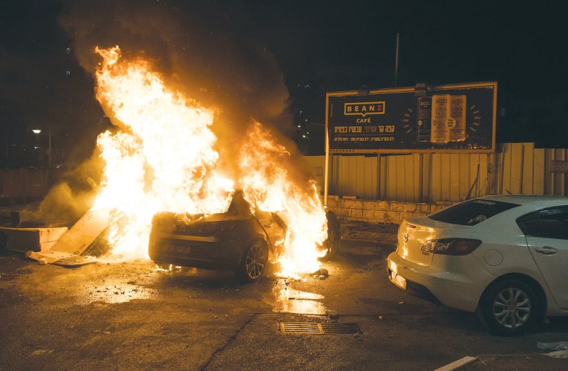 A CAR BURNS during clashes between Arabs and Jews in Acre on May 12.  (photo credit: RONI OFER/FLASH90)