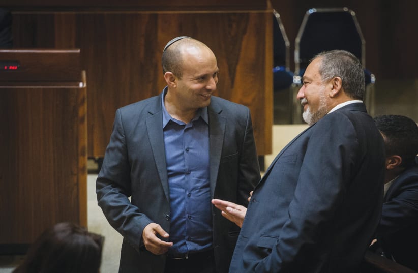 THEN-MINISTER of education Naftali Bennett and MK Avigdor Liberman speak in the Knesset in 2015.  (photo credit: HADAS PARUSH/FLASH90)