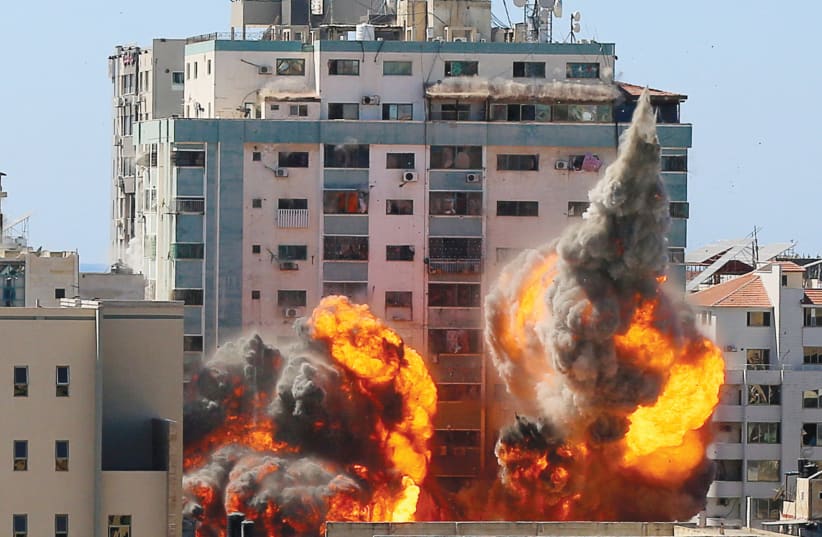 A GAZA CITY building housing the offices of the Associated Press and Al Jazeera is hit by Israeli missile strikes on May 15.  (photo credit: ASHRAF ABU AMRAH / REUTERS)