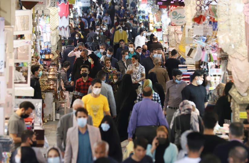 Iranian people walk in Tehran Bazaar, in Tehran (photo credit: MAJID ASGARIPOUR/WANA (WEST ASIA NEWS AGENCY) VIA REUTERS)