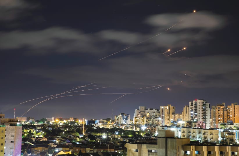 Streaks of light are seen from Ashkelon as the Iron Dome system intercepts rockets launched from the Gaza Strip at Israel on May 17 (photo credit: AMIR COHEN/REUTERS)