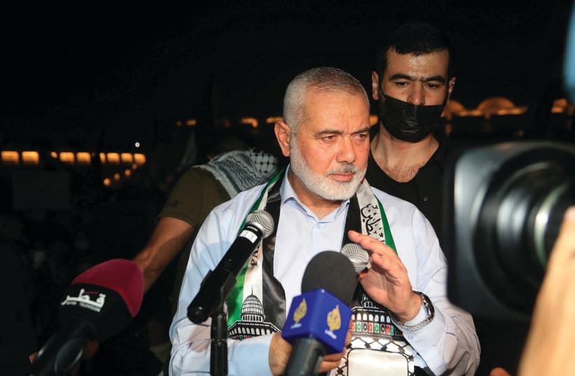 Hamas leader Ismail Haniyeh speaks during a protest to express solidarity with the Palestinian people in Doha, Qatar, May 15, 2021 (photo credit: HUSSEIN SAYED/REUTERS)