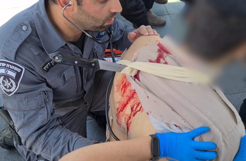 A soldier receives treatment after being stabbed in Jerusalem. (photo credit: POLICE SPOKESPERSON'S UNIT)