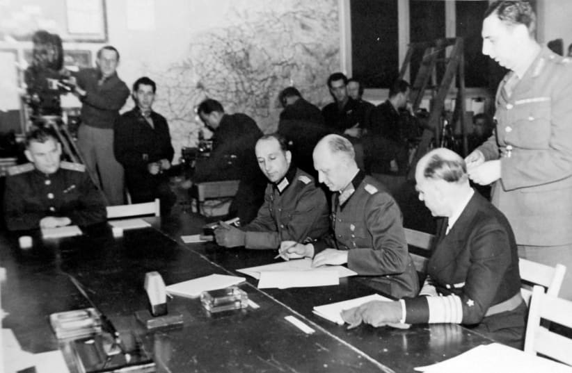 German Chief of Staff Colonel General Alfred Jodl signs the document of “Unconditional Surrender” under which all remaining forces of the German army are bound to lay down their arms in unconditional surrender at the War Room of Supreme Headquarters, Allied Expeditionary Forces, Reims, France May 7, (photo credit: US ARMY/LIBRARY OF CONGRESS COLLECTION VIA REUTERS)