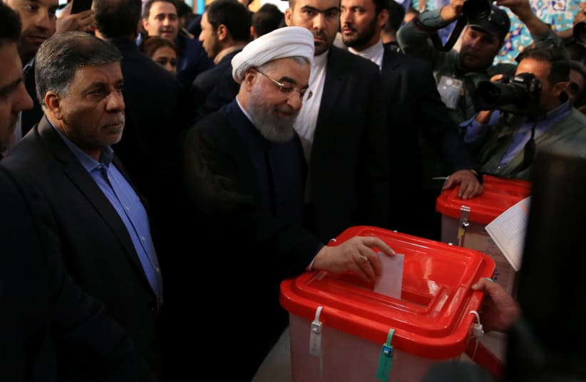 Iranian President Hassan Rouhani casts his vote during the presidential election in Tehran (photo credit: TIMA VIA REUTERS)