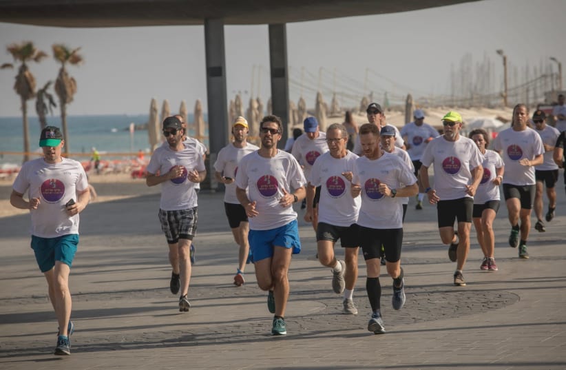 Over 250 people attended a 7-kilometer "Peace Race" on Friday morning in Tel Aviv and Jaffa in a sporting initiative to boost coexistence in Israel amid ongoing tensions. (photo credit: ILAN SPIRA)