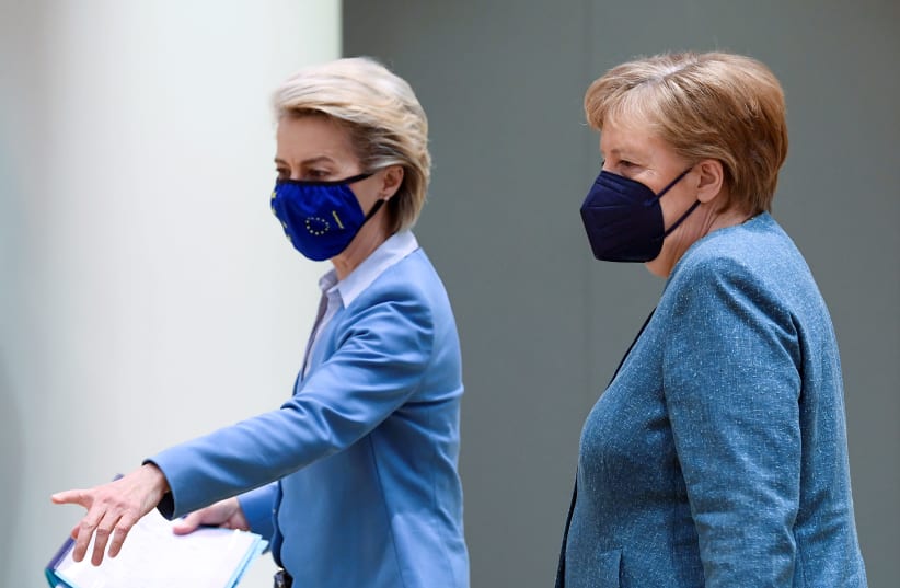 European Commission President Ursula von der Leyen gestures as she walks alongside Germany's Chancellor Angela Merkel at the second day of a face-to-face EU summit in Brussels, Belgium May 25, 2021. (photo credit: JOHN THYS/POOL VIA REUTERS)