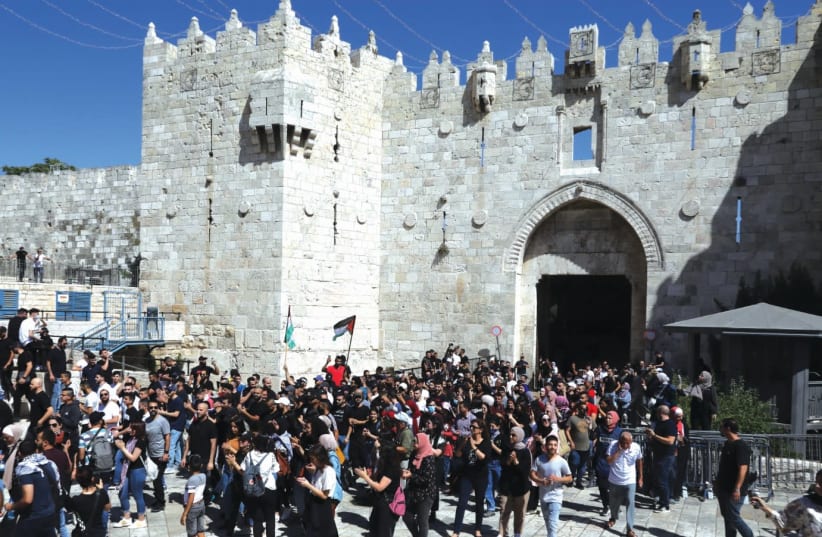 PALESTINIANS DEMONSTRATE outside Damascus Gate in Jerusalem. (photo credit: MARC ISRAEL SELLEM/THE JERUSALEM POST)