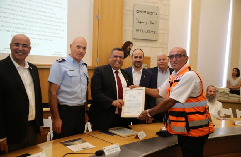 Sami Darwish, seen in 2019 receiving an award from Jerusalem Mayor Moshe Lion for his work in saving lives.  (photo credit: SHIRA HERSHKOP/COURTESY)