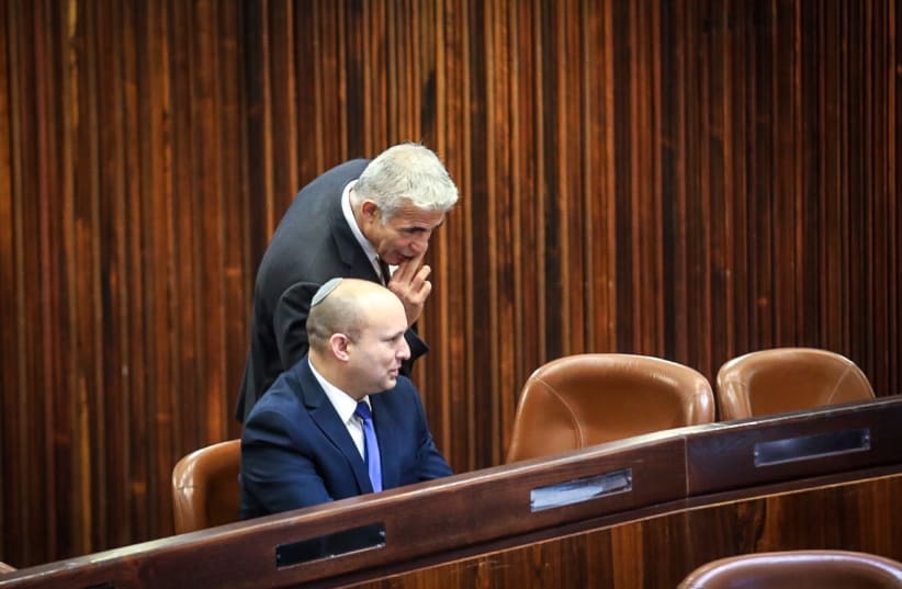 Yamina head Naftali Bennett and Yesh Atid head Yair Lapid in the Knesset Plenum during June 2, 2021 presidential elections. (photo credit: KNESSET SPOKESMAN'S OFFICE)