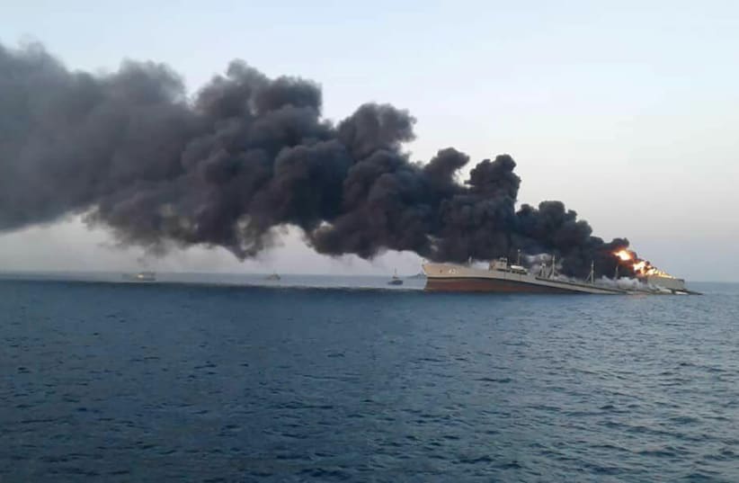 Smoke rises from Iran navy’s largest ship in Jask port in the Gulf, Iran, June 2, 2021. (photo credit: WANA (WEST ASIA NEWS AGENCY) VIA REUTERS)