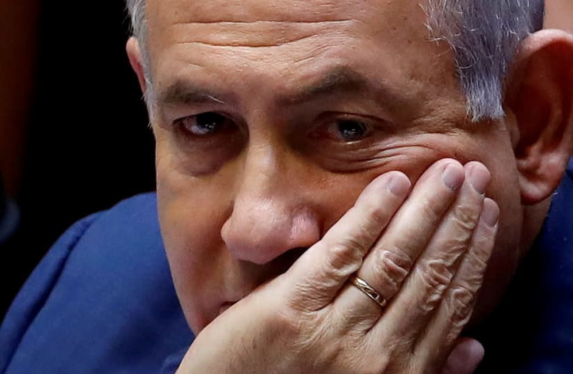Israeli Prime Minister Benjamin Netanyahu sits at the plenum at the Knesset, Israel's parliament, in Jerusalem May 30, 2019. (photo credit: RONEN ZVULUN/REUTERS)