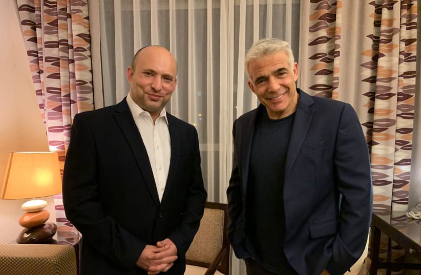 Presumptive Incoming Prime Minister Naftali Bennett and Yesh Atid leader Yair Lapid are photographed together in the Kfar Maccabiah Hotel in Ramat Gan after announcing the formation of a new coalition, on June 3, 2021. (photo credit: COURTESY YESH ATID)