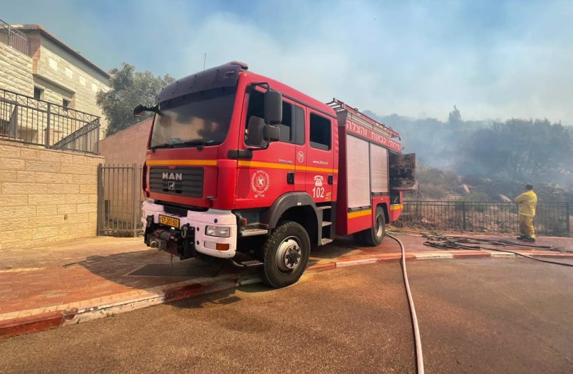 A fire in Tzur Hadassah rages uncontrollably as firefighters work to extinguish it, June 4, 2021 (photo credit: JUDEA AND SAMARIA FIRE DEPARMENT)