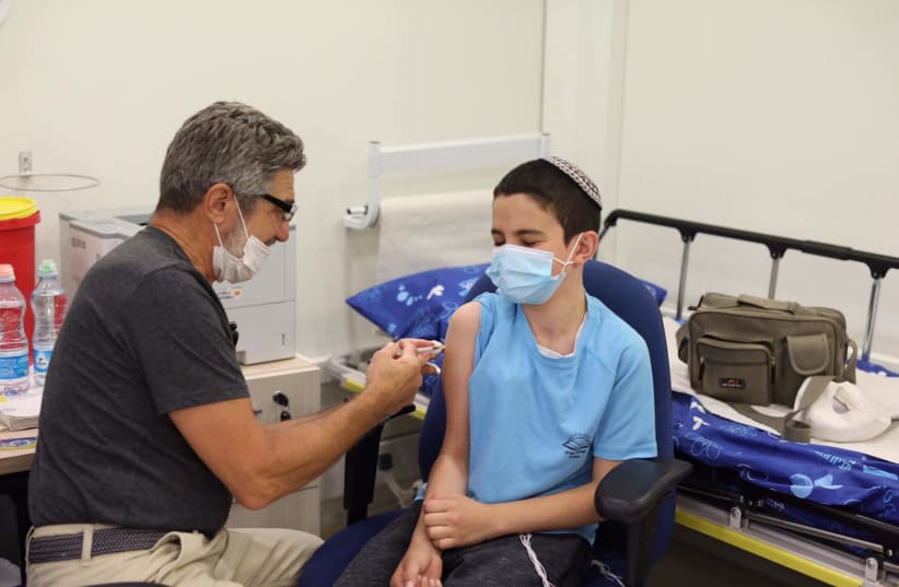 Yossi Guggenheim, 12, getting vaccinated (photo credit: MARC ISRAEL SELLEM)