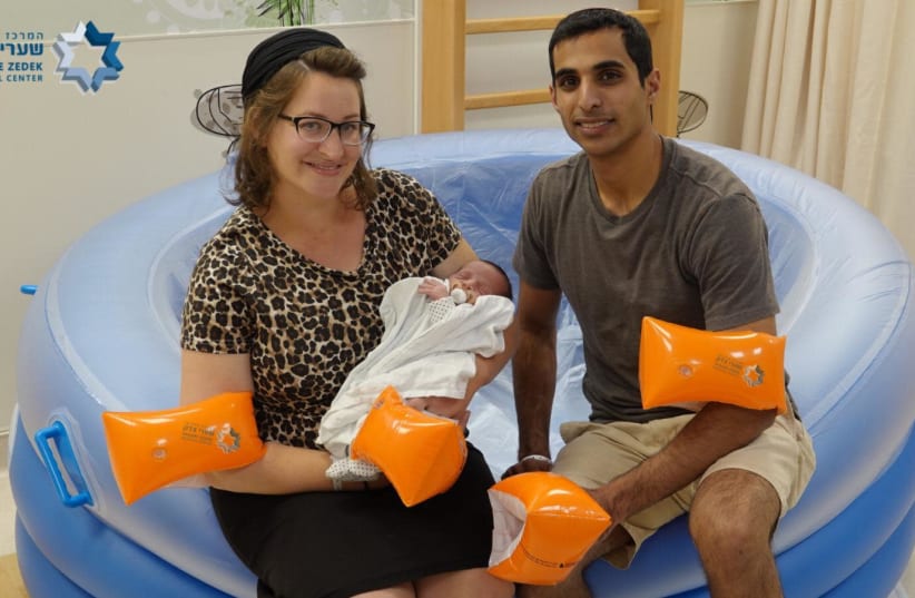 Rachel Richler Vitri and Nadav Vitri celebrate the birth of their son, the 300th baby born in a water birth at Jerusalem’s Shaare Zedek Medical Center.  (photo credit: SHAARE ZEDEK MEDICAL CENTER)