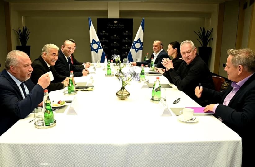 Naftali Bennett and Yair Lapid meet with the party leaders who make up their new coalition on June 6, 2021. (photo credit: ELAD GUTTMAN)