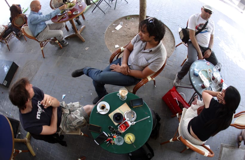 Friends enjoy coffee at a cafe in Jerusalem.  (photo credit: MARC ISRAEL SELLEM)