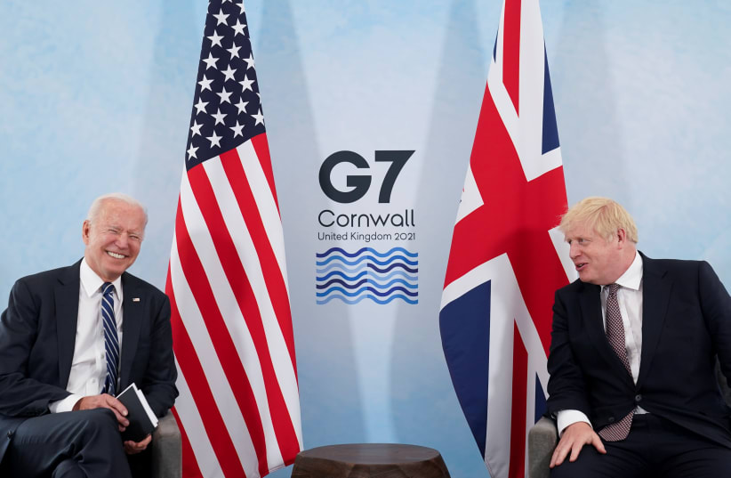 US President Joe Biden laughs while speaking with Britain's Prime Minister Boris Johnson during their meeting, ahead of the G7 summit, at Carbis Bay, Cornwall, Britain June 10, 2021. (REUTERS) (photo credit: REUTERS)
