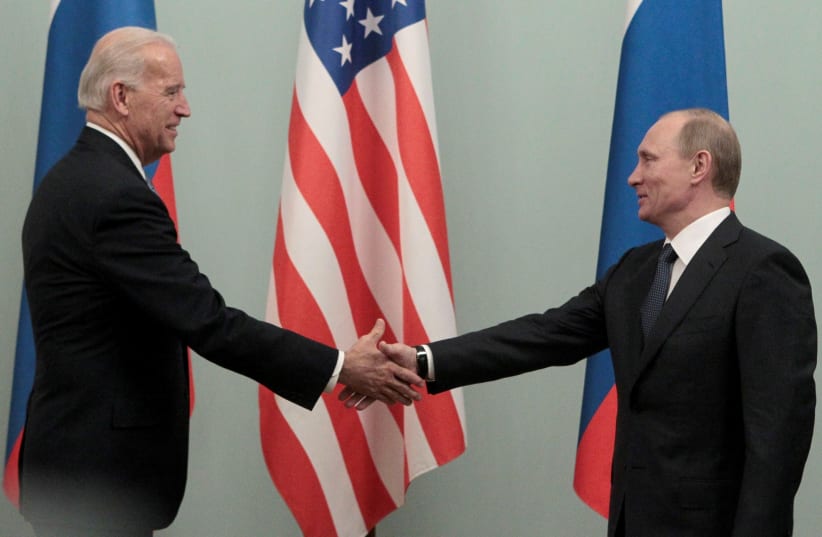  Russian Prime Minister Vladimir Putin (R) shakes hands with then US Vice President Joe Biden during their meeting in Moscow March 10, 2011. (photo credit: REUTERS/ALEXANDER NATRUSKIN/FILE PHOTO)