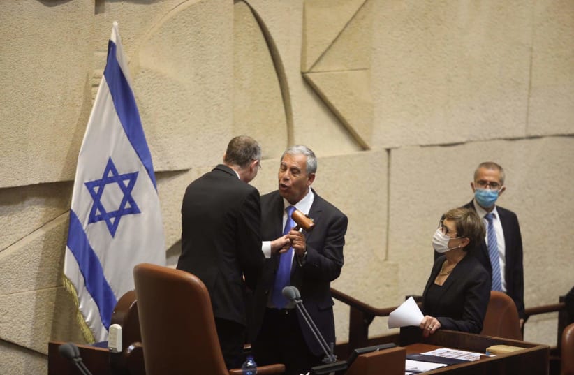 Knesset Speaker Mickey Levy accepts the position from former speaker Yariv Levin, June 13, 2021 (photo credit: MARC ISRAEL SELLEM)