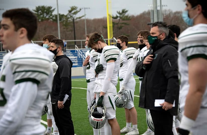 Duxbury football players on the sidelines. A school investigation found that the Boston-area high school team had used terms like "Auschwitz" and "rabbi" in play-calling dating back to at least 2010.  (photo credit: KAREN WONG/JEWISH JOURNAL-MASSACHUSETTS)