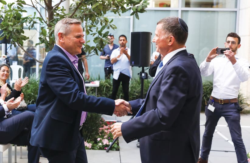 OUTGOING HEALTH Minister Yuli Edelstein (right) welcomes his replacement, Nitzan Horowitz, at a ceremony on Sunday at the Health Ministry in Jerusalem. (photo credit: OLIVIER FITOUSSI/FLASH90)