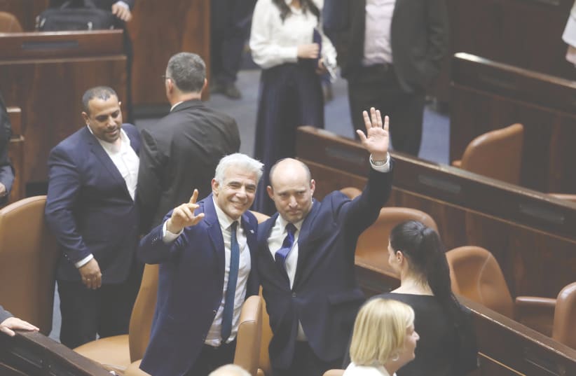 NAFTALI BENNETT and Yair Lapid celebrate the vote that brought their government to power on Sunday night. Can they keep it together? (photo credit: MARC ISRAEL SELLEM/THE JERUSALEM POST)