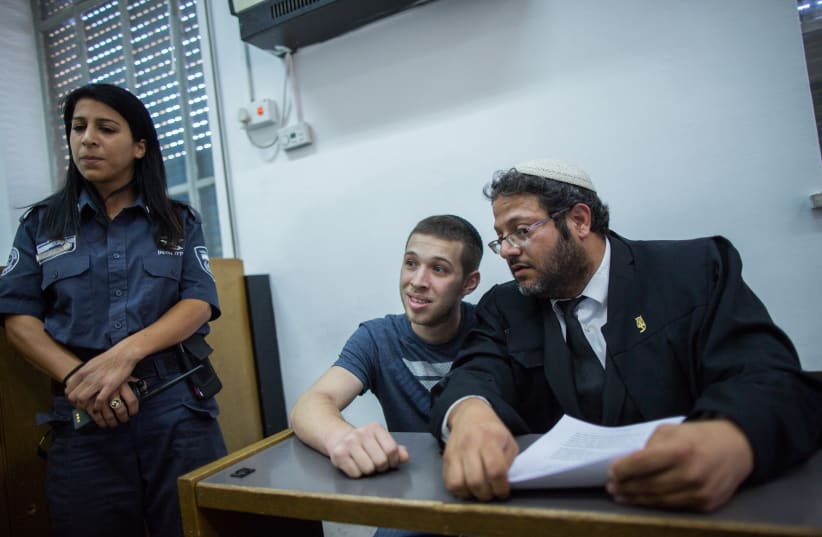 Yitzhak Gabai (C), a member of the right-wing Lehava organization at the courtroom of the District Court in Jerusalem as he arrives to a court hearing on July 22, 2015, Yitzhak Gabai where involved in the arson attack on a Jewish-Arab school in Jerusalem on November 29, 2014. (photo credit: YONATAN SINDEL/FLASH 90)