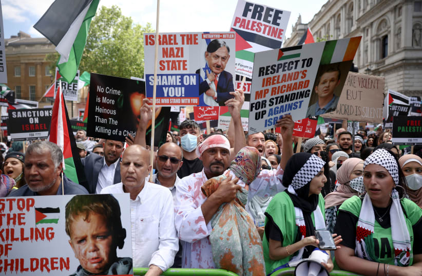 Pro-Palestine protesters demonstrate outside Downing Street in London, Britain, June 12, 2021.  (photo credit: HENRY NICHOLLS/REUTERS)