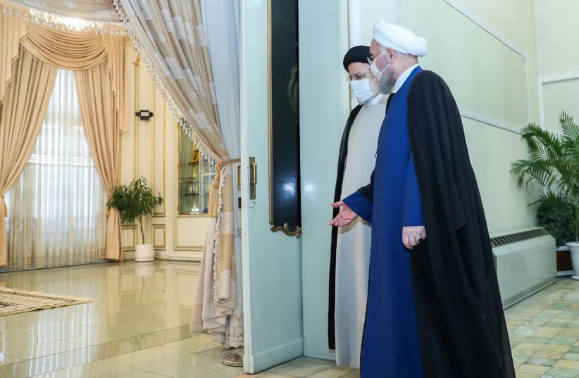 Iran's outgoing President Hassan Rouhani meets with Iran's President-elect Ebrahim Raisi in Tehran, Iran June 19, 2021. (photo credit: OFFICIAL PRESIDENT WEBSITE/HANDOUT VIA REUTERS)