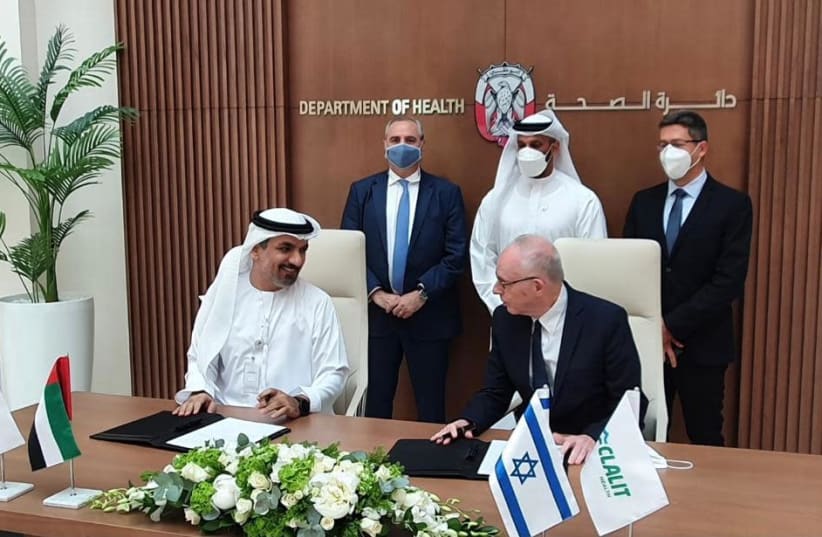 The UAE Health Ministry and Israel's Clalit Health Fund are seen signing a cooperation agreement, on June 22, 2021. (photo credit: CLALIT HEALTH SERVICES)